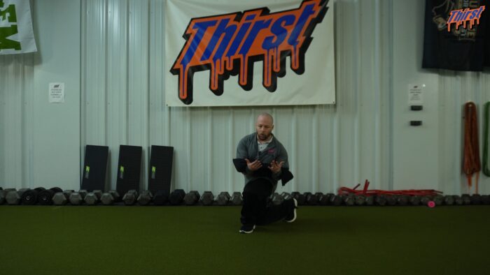 Sandbag Zercher Curtsy Lunge